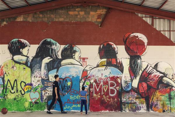 Migranti, In Grecia i rifugiati disegnano un murale per la pace e l'unità